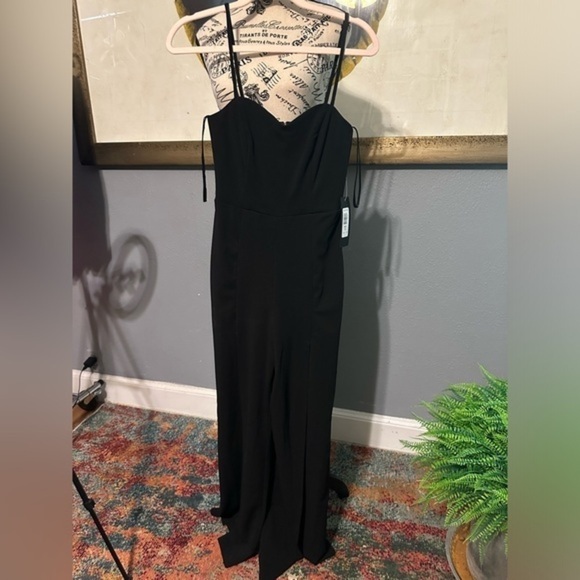 bebe Pants - Bebe NWT jumpsuit. Black. Sexy slits up leg. Has stretch. Xs